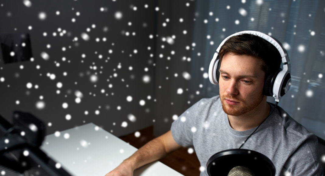 man in headset playing computer video game at home