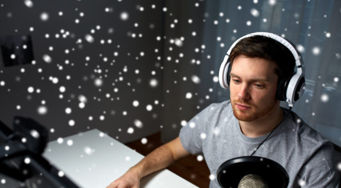 man in headset playing computer video game at home