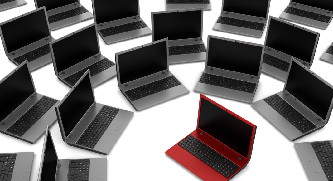 red laptop among gray similar isolated on white background