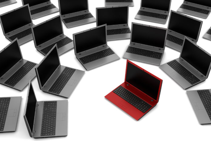 red laptop among gray similar isolated on white background
