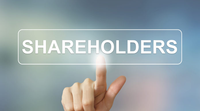 business hand clicking shareholders button on blurred background