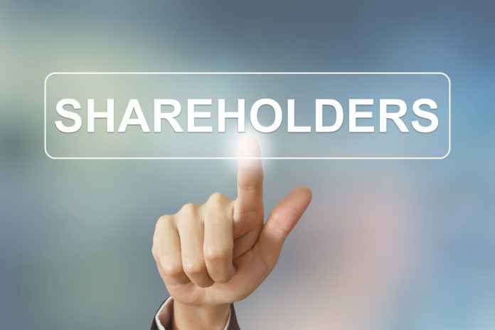 business hand clicking shareholders button on blurred background