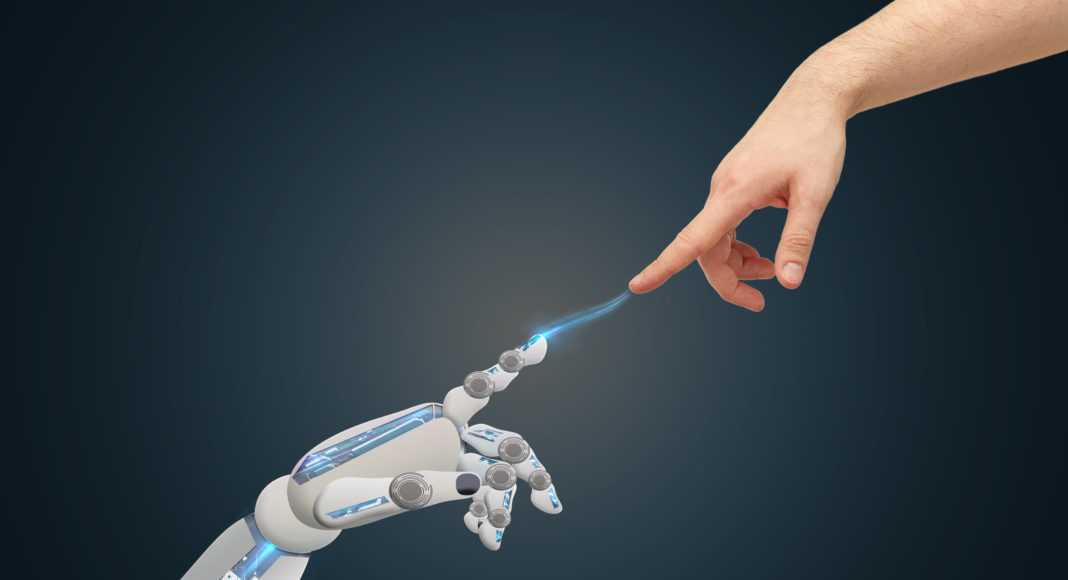 human and robot hands reaching to each other
