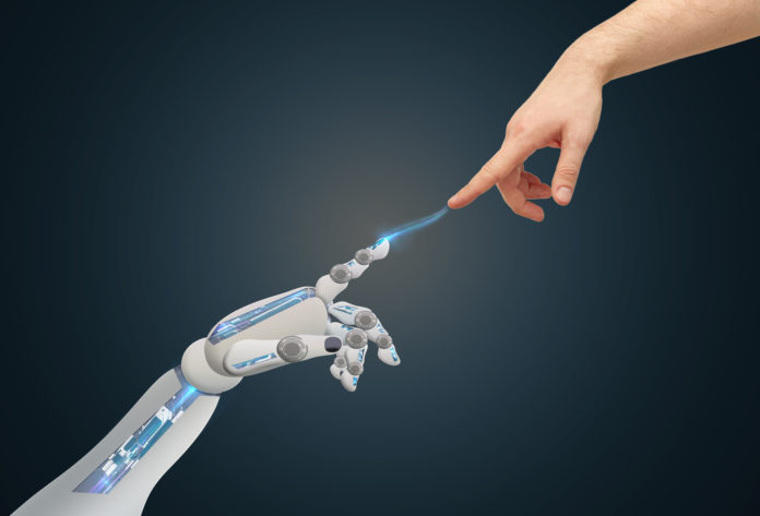 human and robot hands reaching to each other