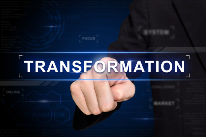 business hand pushing transformation button on virtual screen