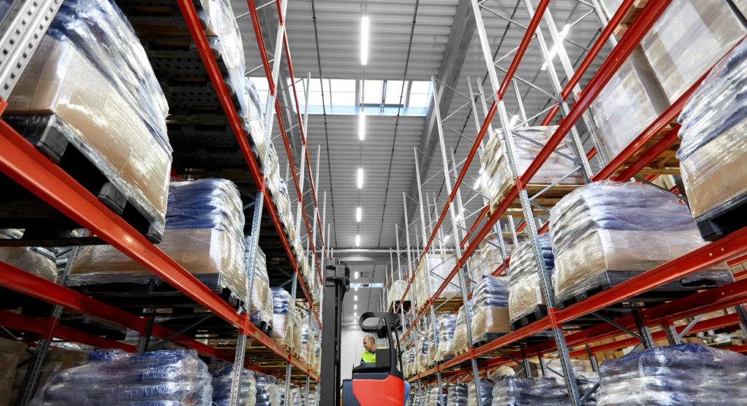 male loader operating forklift at warehouse
